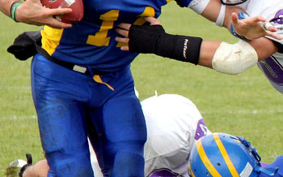 Ansbach quarterback Dominic Barrale fends off a Mannheim tackler and picks up yardage during Ansbach&#39;s 44-6 win Saturday. Barrale ran for one touchdown and a two-point conversion, and passed for two TDs and a two-point conversion.