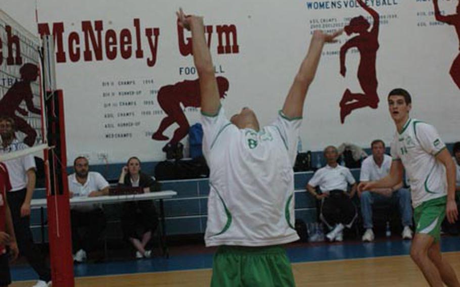 Naples’ Jonathan Higgins sets the ball behind him to Abram Campbell during the Wildcats’ 25-22, 25-22, 15-25, 25-15 victory over Aviano on Saturday in the DODDS-Europe boys volleyball championships. The Wildcats finished the season undefeated.