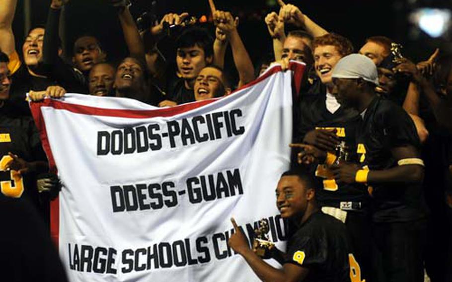 Kadena Panthers players rally around the title banner.