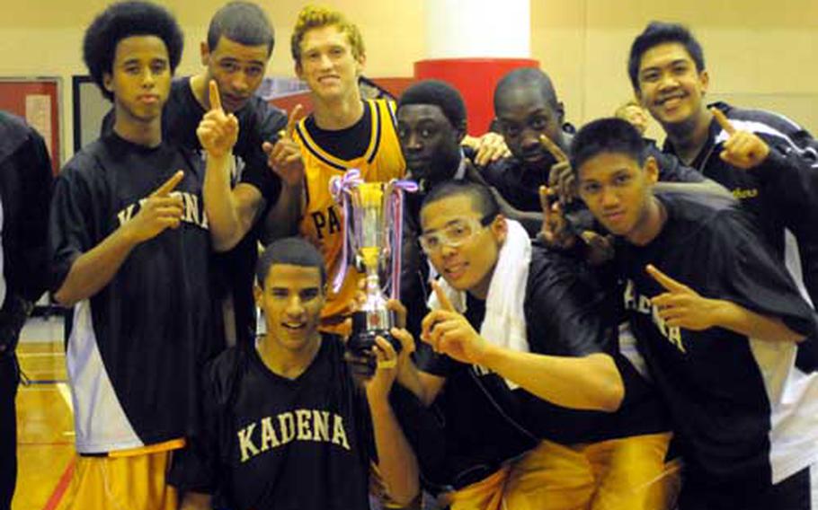 Kadena Panthers players mug for the camera around the first-place trophy after the boys championship game in the 40th Hong Kong International Holiday Basketball Tournament at high school gym, Hong Kong International School, Red Hill One, Tai Tam, Hong Kong. Kadena beat host Hong Kong International 81-65 for the Panthers&#39; first championship in this tournament.