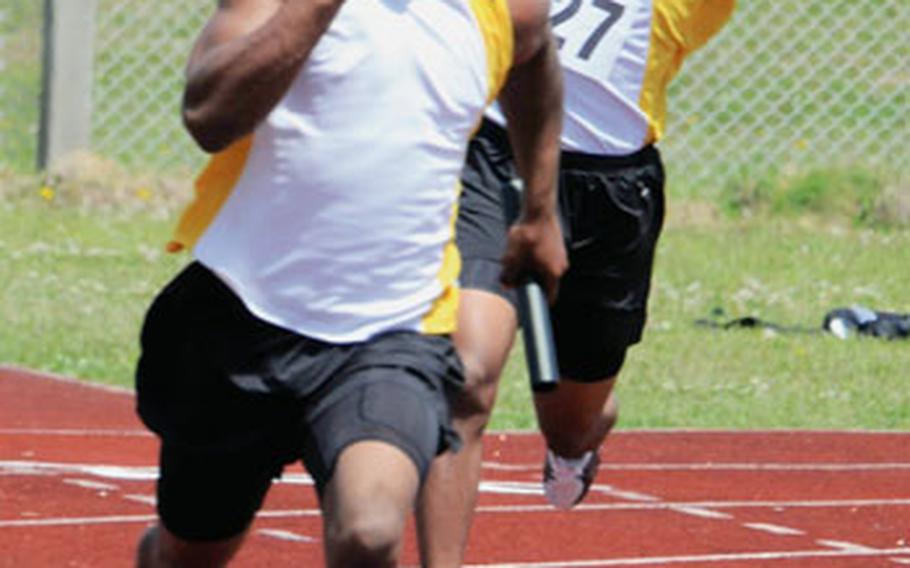 Kadena Panthers sophomore sprinter Shariff Coleman pounds for home with the baton as sophomore teammate Thomas McDonald (127) exults in the background during the boys 400-meter relay in the 7th Alva W. “Mike” Petty Memorial Track and Field Meet at Mike Petty Stadium, Kubasaki High School, Camp Foster, Okinawa. Kadena broke its own two-year-old meet record, clocking 45.18 seconds.