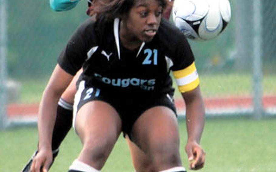 Osan American sophomore midfielder Jasmine Pressley (21) heads the ball in front of Matthew C. Perry forward Anne Naseer during the Far East High School Girls Class A Soccer Tournament championship. The Cougars captured the title and matched the school’s feat of titles in volleyball, basketball and soccer in the same school year.