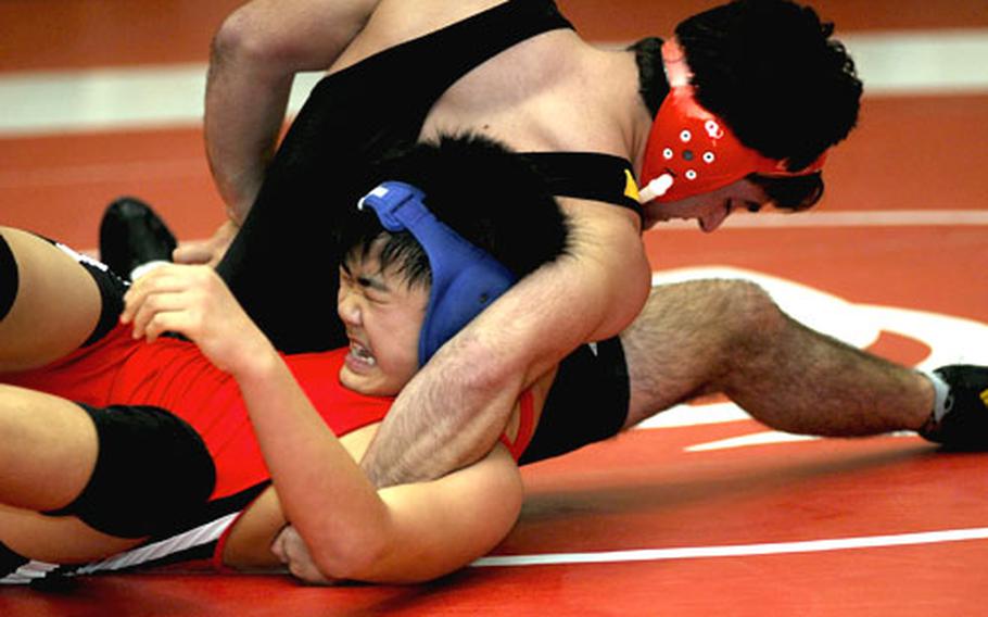 Harry Bloom of Kadena twists the shoulders of Shonan Military Academy&#39;s Yura Naito toward the mat during Saturday&#39;s 158-pound gold-medal bout in the 2010 Nile C. Kinnick Invitational "Beast of the Far East" Wrestling Tournament. Bloom pinned Naito in 1 minute, 16 seconds.