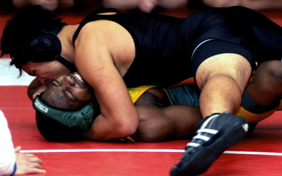 Cody Reyes of Kadena puts the squeeze on Darrel Roberson of Robert D. Edgren during Saturday&#39;s 148-pound gold-medal bout. Reyes pinned Roberson in 1 minute, 15 seconds.