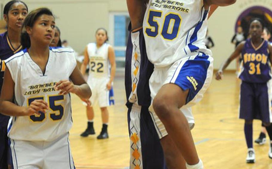 Bamberg&#39;s Racquel Davis, right, goes to the hoop against Mannheim&#39;s Takiara Fowlkes during a game in Mannheim on Jan. 9. Davis scored 19 points in the game. At left are Kadedra Lea of Mannheim and Diandra Quashie of Bamberg.