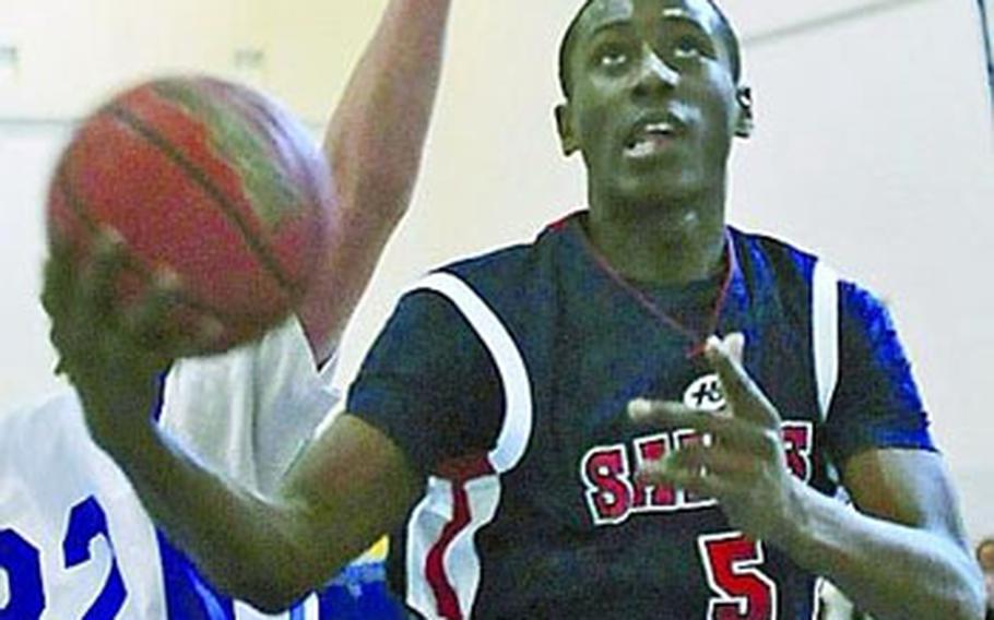 Aviano High School senior Jamal Tuck can score from inside and outside. He’s an adept three-point shooter, but can drive past defenders who play too close — as evidenced by this layup against Sigonella.