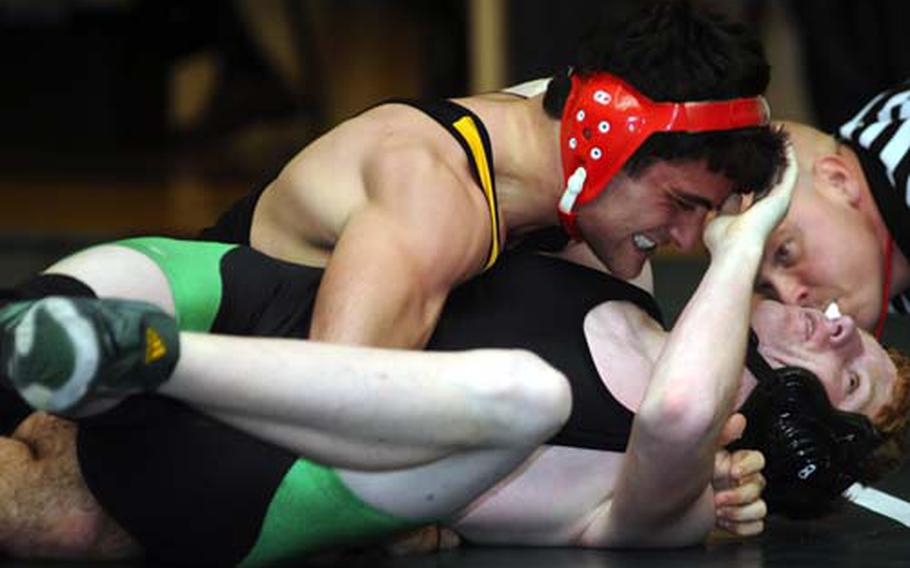 Kadena Panthers senior two-time defending Far East gold medalist Harry Bloom wrenches the shoulders of Kubasaki Dragons&#39; Schuyler Piatt to the mat during the 158-pound bout in Friday&#39;s dual-meet phase of the 3rd Rumble on the Rock Wrestling Tournament at Dragons&#39; Den, Kubasaki High School, Camp Foster, Okinawa. Bloom pinned Piatt in 1 minute, 7 seconds.