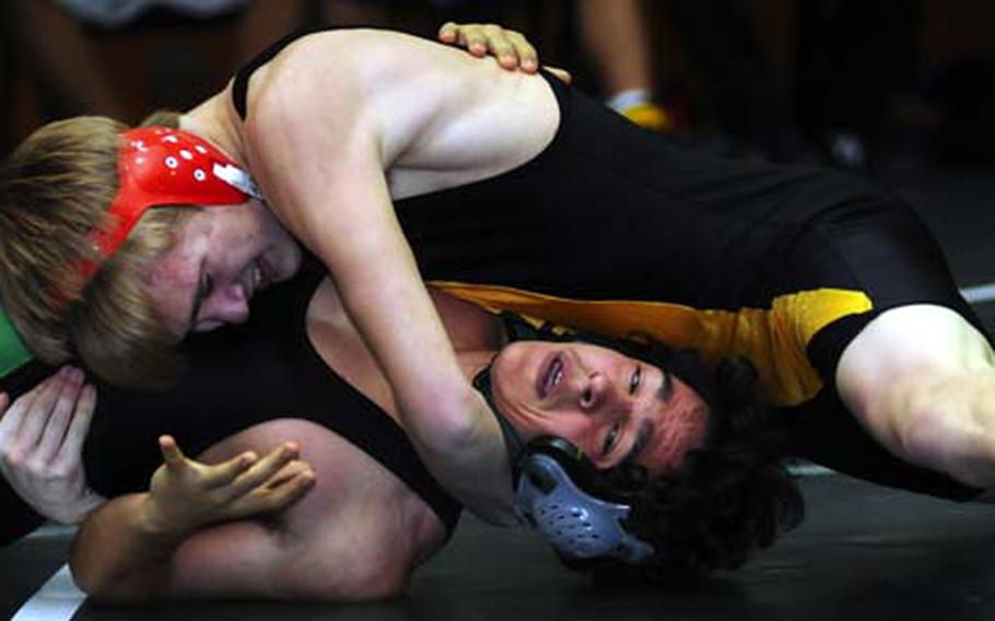 Kadena Panthers junior Jacob Bishop wrenches the shoulders of Kubasaki Dragons&#39; Brandyn Hewson to the mat during the 141-pound bout in Friday&#39;s dual-meet phase of the 3rd Rumble on the Rock Wrestling Tournament at Dragons&#39; Den, Kubasaki High School, Camp Foster, Okinawa. Bishop pinned Hewson in 2 minutes, 54 seconds.