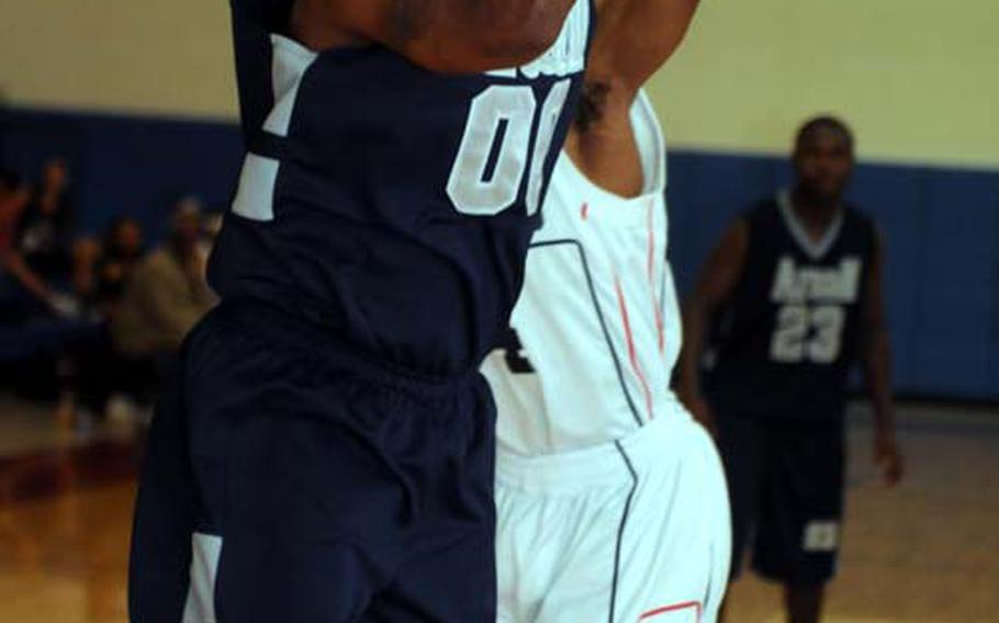 Brett Eason of Area III All-Stars shoots past an Osan Air Base defender during Saturday’s champion-bracket game in the March Madness Tournament. Eason had 22 points in a losing cause.