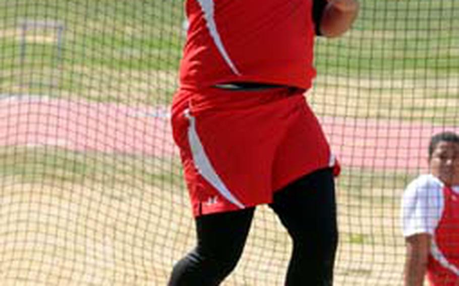 Adam Cason of Nile C. Kinnick tosses the discus during Saturday&#39;s mixed DODEA Japan/Kanto Plain Association of Secondary Schools track and field meet at Bonk Field, Yokota High School, Yokota Air Base, Japan. Cason won with a throw of 33.2 meters and Kinnick won 22 of a possible 28 gold medals.