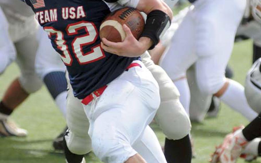 Team USA running back Michael Spencer of Zama American skirts left end for a big gain against Team Kanagawa during Sunday’s Camellia Bowl exhibition football game at Kawasaki Stadium, Kawasaki, Japan. Spencer earned MVP honors with 175 yards and three touchdowns on 11 carries in a 61-0 victory.