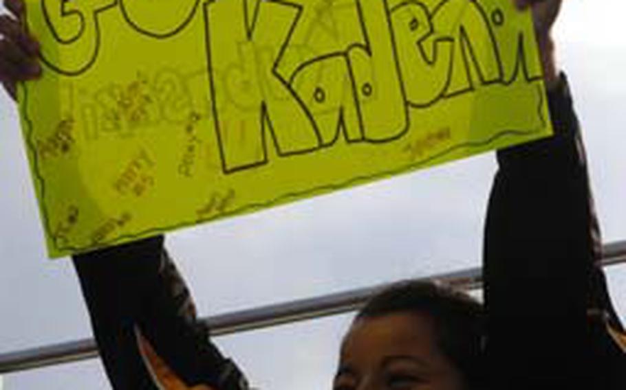 Kadena Panthers girls soccer player Chasity Cordova holds a sign in support of her boys counterparts during Friday&#39;s Okinawa Activities Council season-opening matches at Ryukyu Middle School, Kadena Air Base, Okinawa. Kadena&#39;s boys beat Kubasaki 5-1 and Kadena&#39;s girls also won 1-0.