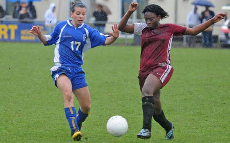 Wiesbaden&#39;s Celina Ponte, left, and Vilseck&#39;s Josie Rodriguez fight for the ball in the season-opener for both teams on Saturday. The game, played in the rain, ended 1-1.