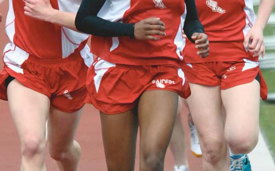 Kaiserslautern’s Ashley Santos, center, leads teammates Amber Core, left, and Colleen Davis into the final lap of the girls 1,500-meter race at Ramstein on Saturday. Santos won the race in 5 minutes, 27.59 seconds, ahead of Core and Davis.