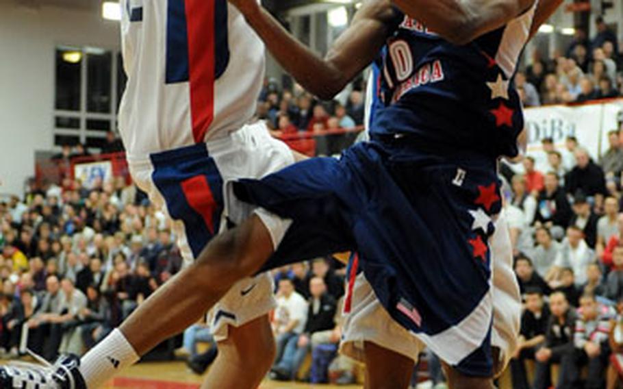 Kevin Ware of the United States gets stopped by France&#39;s Rudy Gorbert, left, and Yannis Morin.