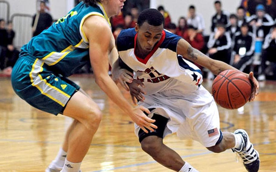 Ryan Boatright of the United States, right, drives against Australia&#39;s Corban Wroe in their second round game at the Albert Schweitzer tournament. Australia defeated the U.S. 79-66, but both teams advanced to Friday&#39;s semifinals. Boatright led all scores with 27, while Wroe contributed 12 to Australia&#39;s victory.