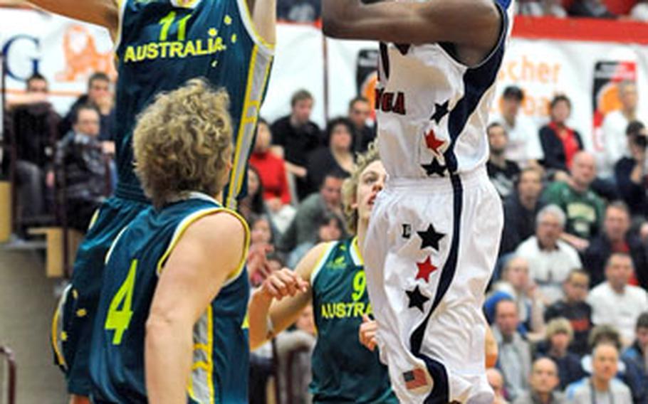 Australia&#39;s Mitchell Creek, left, goes high to block a shot by Kevin Ware of the U.S. Creek led the Australians with 23 points, while Ware had eight.