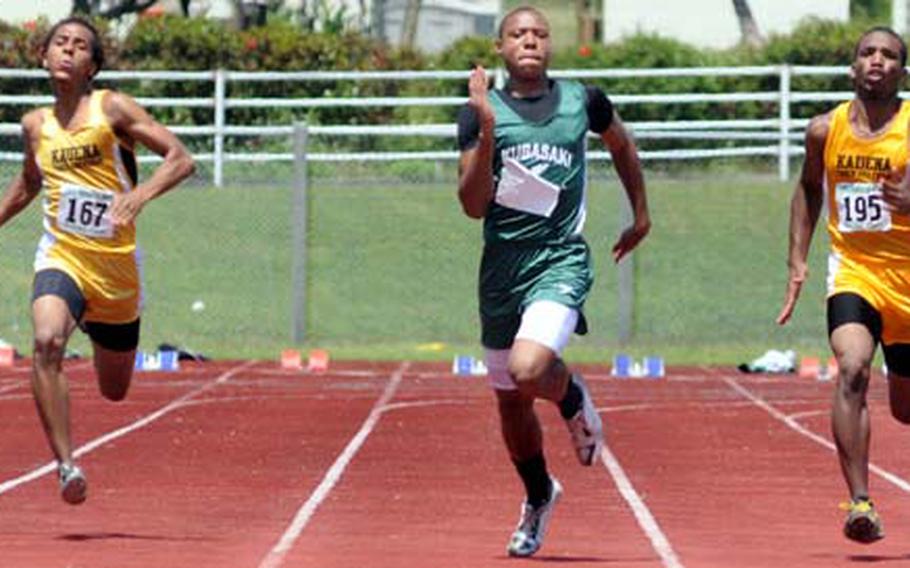 Kubasaki Dragons sophomore A.J. Watson is flanked by Kadena Panthers Perry Scott and Lotty Smith during Saturday's boys 100-meter dash in the 8th Alva W. "Mike" Petty Memorial Track and Field Meet at Mike Petty Stadium, Kubasaki High School, Camp Foster, Okinawa. Watson won with a time of 11.22 seconds.