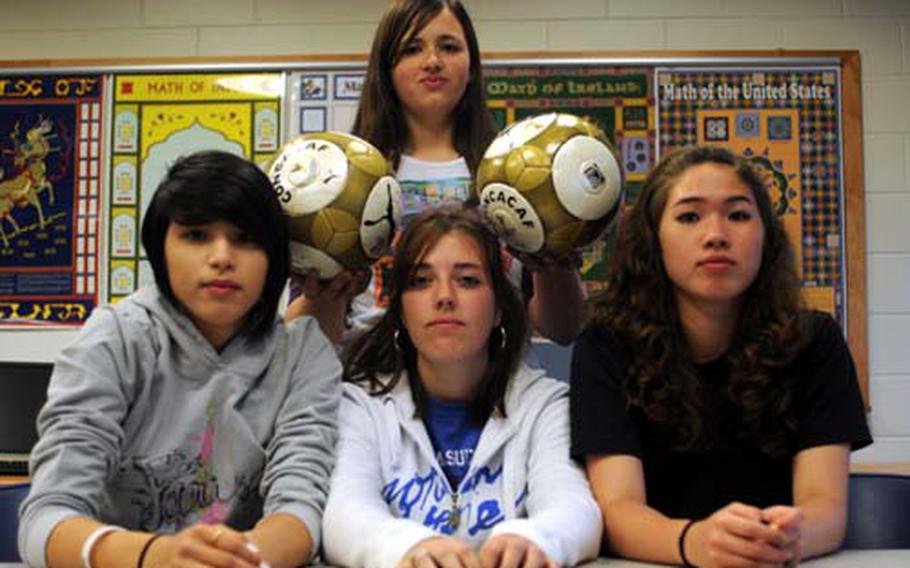 Osan American Cougars strikers Angela Frisby, left, and Stephanie McDole, right, midfielder Courtney Ouellette, center, and goalkeeper Deanna Polaski, standing.