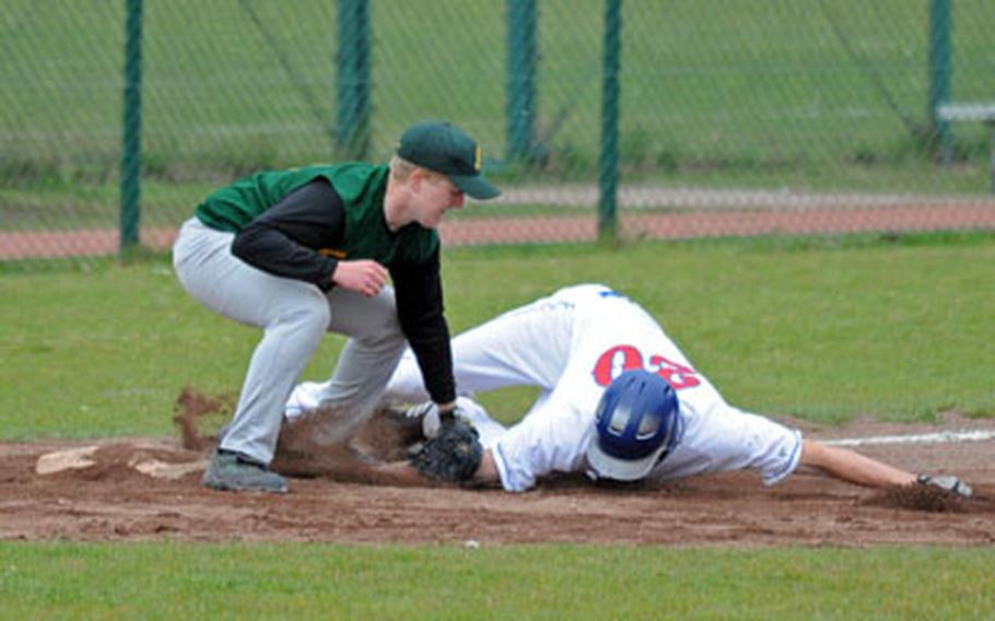 Ramstein&#39;s Josh Sloan, right, can&#39;t get low enough to escape the tag by SHAPE&#39;s Joe Broughton in the first game of a doubleheader in Ramstein, on Saturday. Ramstein won the game 8-5.