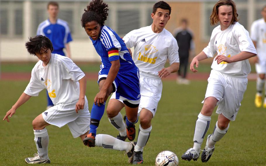Ramstein’s Glenn Verley, second from left, is surrounded by Heidelberg players as he sends the ball upfield in a game against Heidelberg on April 8. Heidelberg’s players are, from left, Grant Lee, Andres Nunez and Colin lSchwallbach. Ramstein is undefeated going into the DODDS-Europe championships, which begin Wednesday, while Heidelberg is the No. 3 seed.