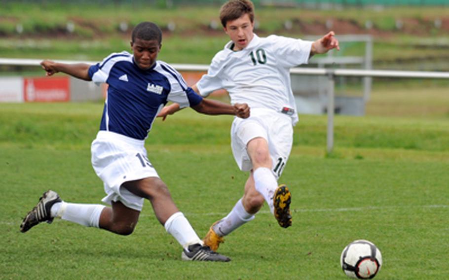 Alconbury&#39;s Ernestas Tyminas, right, gets a shot off past the defense of Lajes&#39; Brinson Satterwhite in a boys Division III opening-day match at the DODDS-Europe soccertournament in Kaiserslautern, Germany, on Thursday. Alconbury won 7-0.