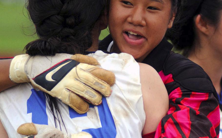 Seoul American goalkeeper Liz Gleaves embraces teammate Lee Ann Schade after Friday&#39;s championship match in the 2010 Far East High School Girls Class AA (large schools) Soccer Tournament at Mike Petty Stadium, Kubasaki High School, Camp Foster, Okinawa. Schade scored the lone goal in the penalty-kick shootout and Gleaves stopped three Faith Academy shots as the Falcons won their first Class AA title, 1-0 over the Vanguards.