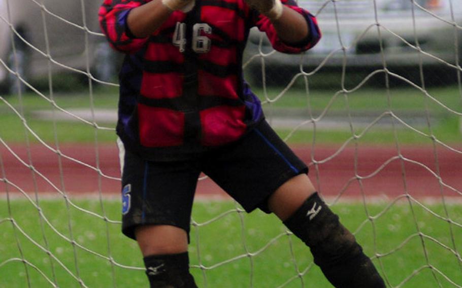 Seoul American goalkeeper Liz Gleaves eyes a Faith Academy shot during the penalty-kick shootout phase of Friday&#39;s championship match in the 2010 Far East High School Girls Class AA (large schools) Soccer Tournament at Mike Petty Stadium, Kubasaki High School, Camp Foster, Okinawa. Gleaves stopped three shots as the Falcons won their first Class AA title, 1-0 over the Vanguards.