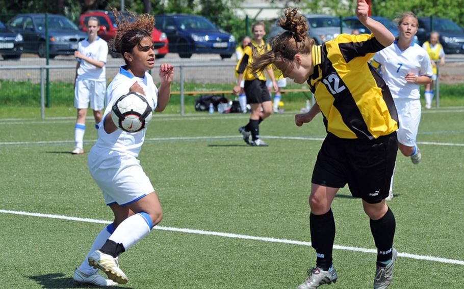 Patch's Emma Murray heads the ball past Ramstein's Italia Rivera in Patch's semifinal win over Ramstein in the DODDS-Europe girls Division I soccer tournament on Friday. Murray scored four goals in an 8-1 win.