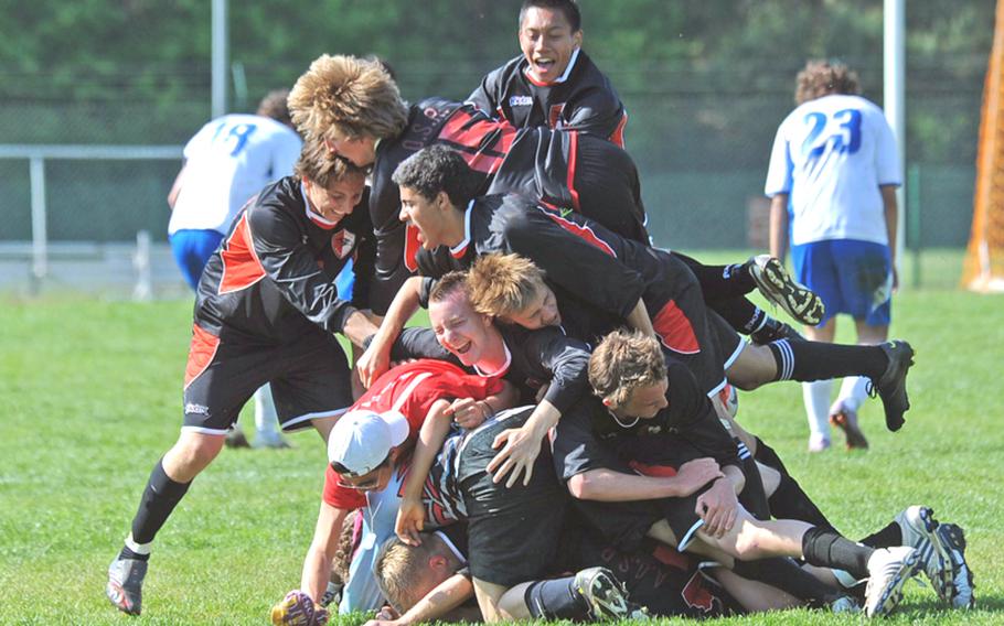 American Overseas School of Rome players celebrate their  Division II title, after beating top-seeded Marymount 2-1, at the DODDS-Europe soccer championships in Ramstein, Germany, on Saturday.