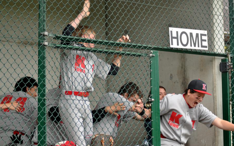 Kaiserslautern players erupt out of the dugout after Aaren Blossom hit a grand slam against Vilseck during opening-day action in the Division I baseball tournament at Ramstein Air Base, Germany, on Thursday. Kaiserslautern won 10-2. 