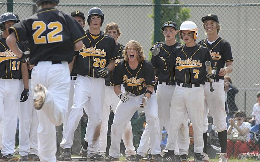 Players from Patch greet junior Cavan Cohoes after he hit a two-run home run to tie the game 8-8 during the European Division I high school baseball championship game at Ramstein Air Base on Saturday. Patch went on to defeat Ramstein 10-9.