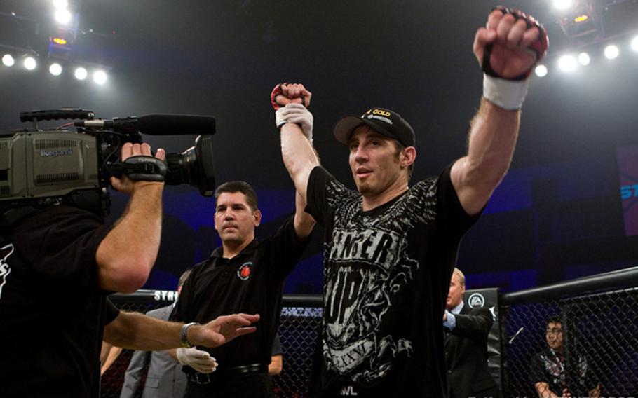 Tim Kennedy celebrates his victory over Zak Cummings in his most recent mixed martial arts fight in September. Kennedy, a Texas National Guardsman, is fighting Wednesday.