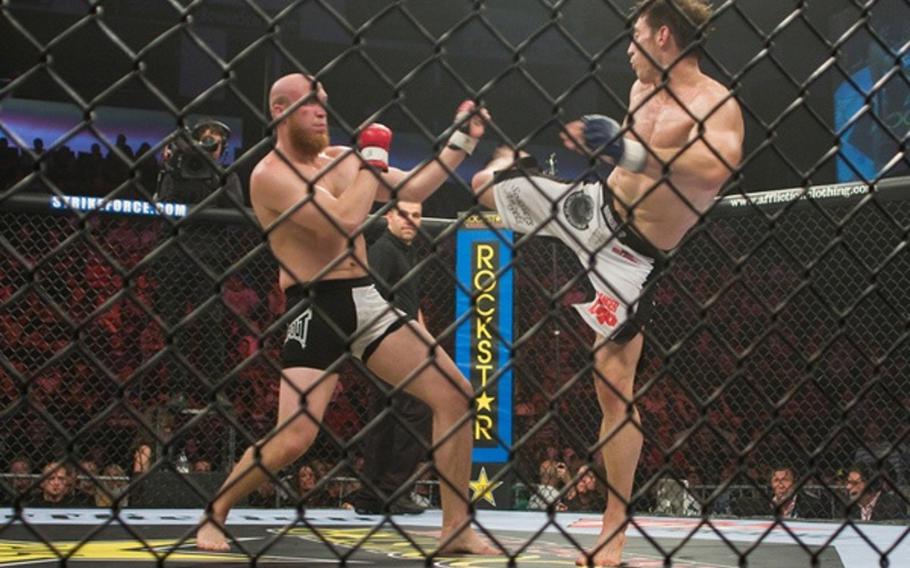 Tim Kennedy, right, delivers a roundhouse kick to Nick Thompson during a mixed martial-arts fight in June 2009. Kennedy, a Texas National Guardsman, is fighting again on Wednesday.