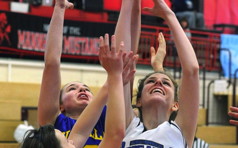 Brussels' Kathleen Anderson, right, battles Sigonella's Adrenne Moore, left, and Tracy Ewert  for a rebound in the DODDS-Europe basketball tournament in February. Anderson was named the 2010 DODDS female athlete of the year.