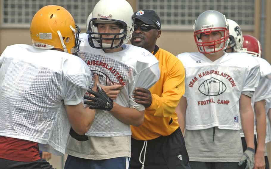 Pittsburgh Steelers running backs coach Kirby Wilson, third from left, gives pointers to players participating in the four-day football camp in Miesau, Germany.
