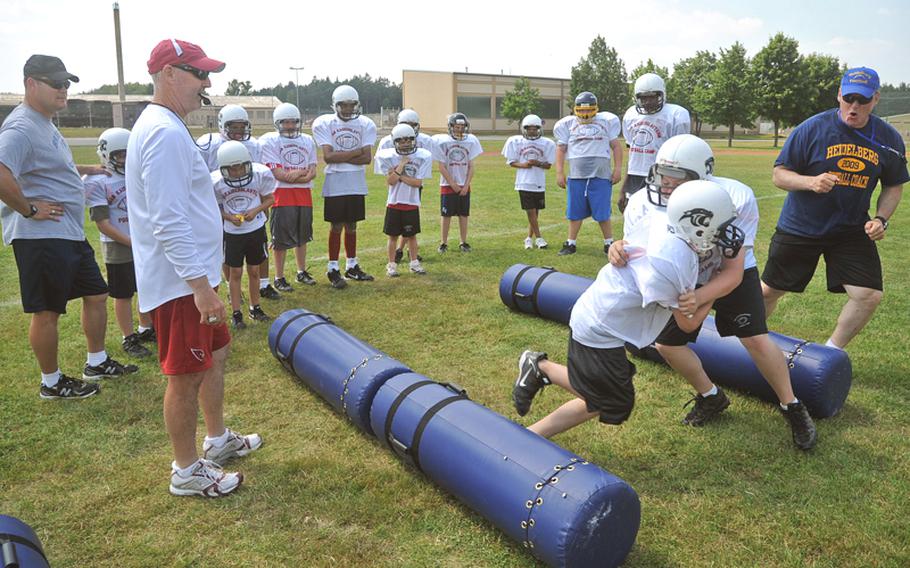 Participants go through drills Thursday, the second day of the football camp in Miesau, Germany, under the watchful eyes of Arizona Cardinals  assistant defensive backs coach Rick Courtright, third from left.