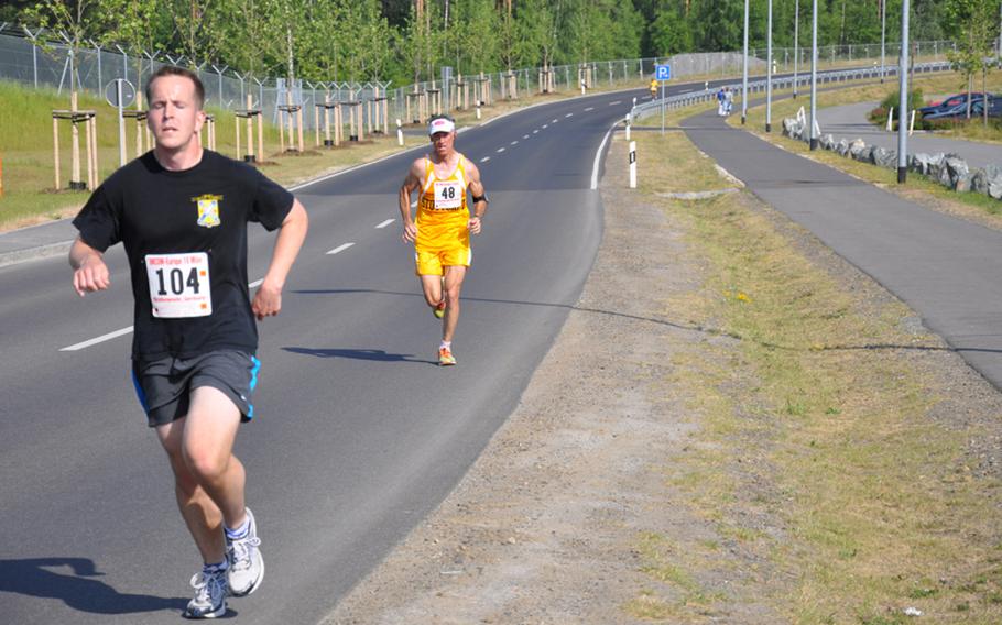 Gregory Mularz of Grafenwöhr leads William Smith of Stuttgart at the nine-mile mark of the U.S. Forces-Europe Army 10-Miler Qualifier on Saturday. Smith ended up passing Mularz as the two civilians finished the race in around 70 minutes.