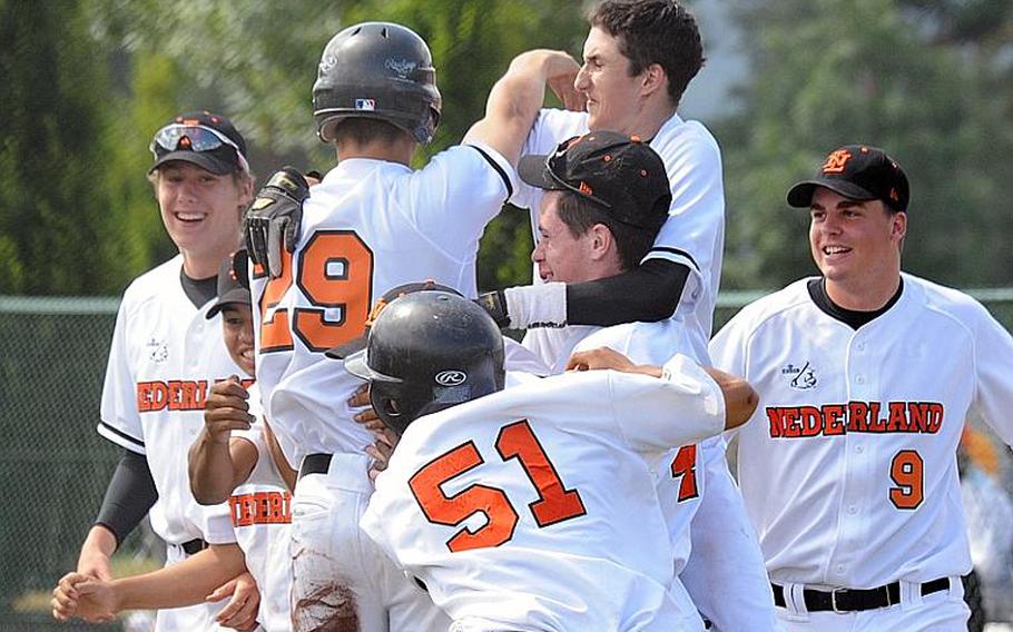 Members of the Netherlands team celebrate their 10-0 victory over KMC in the title game of  Little League Baseball&#39;s Europe-Middle East-Africa Big League regional tournament in Ramstein, Germany, on Thursday. The win sends them to the Big League World Series in Easley, S.C.