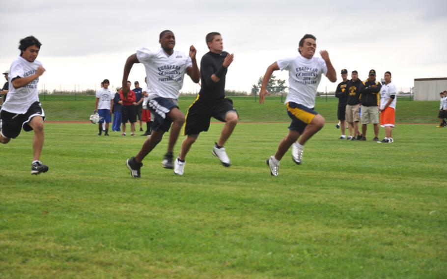 High school football players run for the finish line during a 40-yard dash competition Wednesday at the DODDS-Europe football camp in Ansbach, Germany, attended by about 375 high-school-aged players.