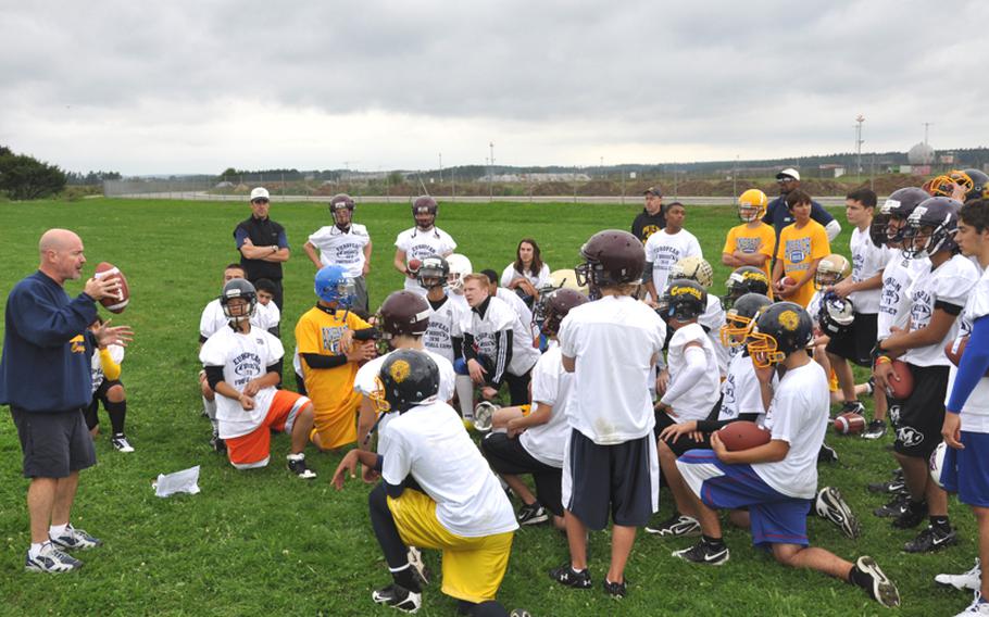 Marcus George, coach of the Ansbach High School football team, gives pointers to a group of high school quarterbacks Wednesday at the DODDS-Europe football camp in Ansbach, Germany.