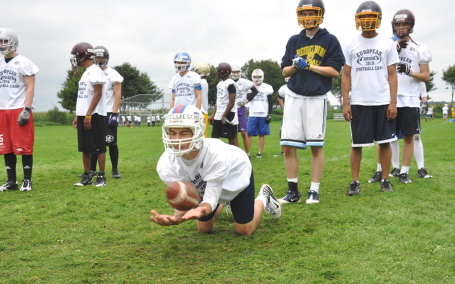 Andrew Grotelueschen, a senior receiver from Ramstein High School, dives forward to make a catch Wednesday at the DODDS-Europe football camp in Ansbach, Germany, attended by about 375 high-school-aged players.