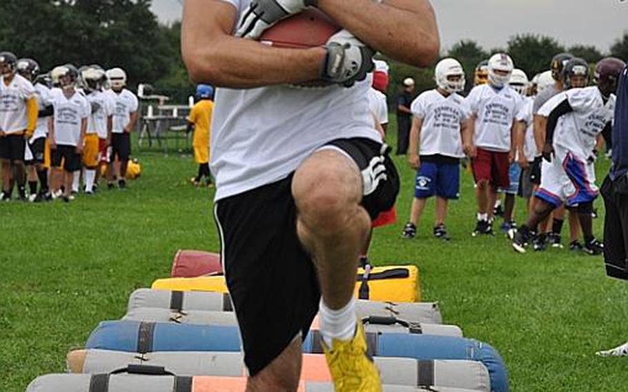 Nickolas Setter, a Patch High School senior, carries the ball during a running back drill Wednesday during an exercise Wednesday at the DODDS-Europe football camp in Ansbach, Germany.