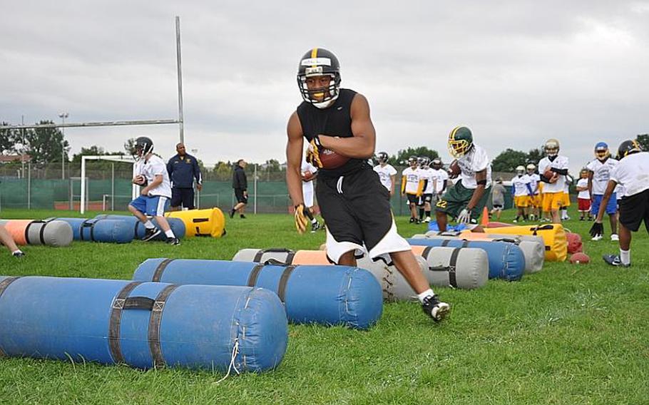 Kenny Hall, a senior running back from Patch High School, weaves his way around obstacles during an exercise Wednesday at the DODDS-Europe football camp in Ansbach, Germany.