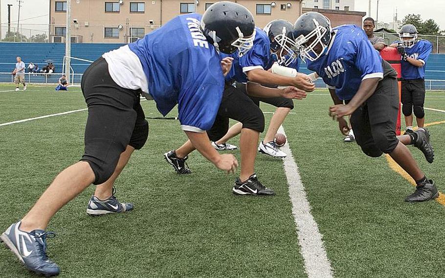 Interior linemen lock horns during Wednesday&#39;s Seoul American Falcons football practice at Sims Field, Seoul American High School, South Post, Yongsan Garrison, South Korea.