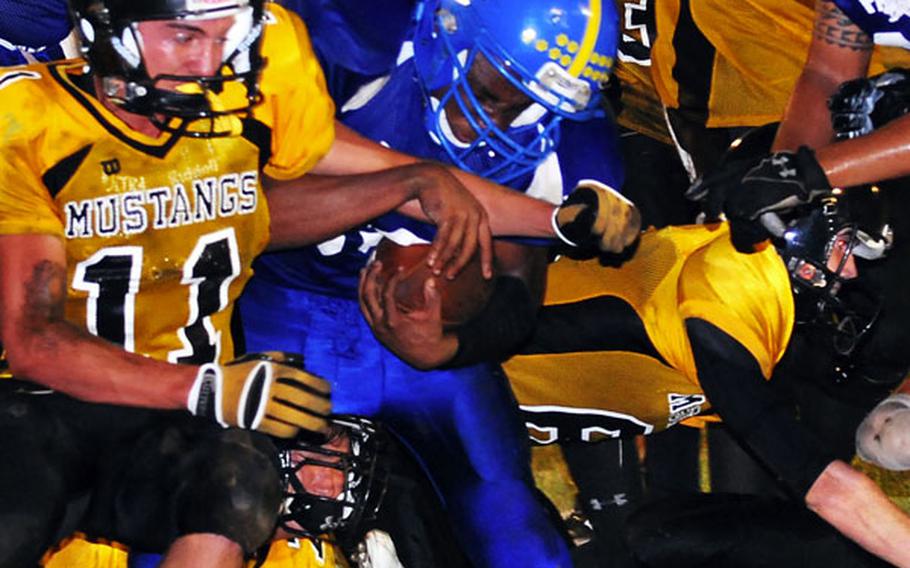 Yokota Panthers senior running back Devin Day is surrounded by teammates and American School In Japan Mustangs defenders during Friday's Kanto Plain Association of Secondary Schools football game at Bonk Field, Yokota High School, Yokota Air Base, Japan. Day rushed 25 times for 178 yards and five touchdowns as the Panthers routed the Mustangs 46-7.