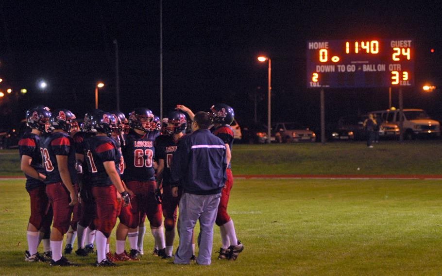 Lakenheath Lancers head coach Matt Martinez talks with his team after their opponents, Filton Academy, returned the second-half kickoff 80 yards for a touchdown and a 24-0 lead. Filton Academy won 31-6.