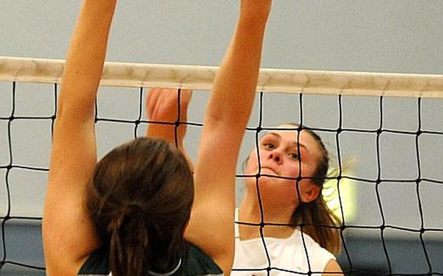 Vilseck's Anna Muzzy, right, slams the ball over the attempted block of SHAPE's Liene Bauska during last year's DODDS-Europe volleyball tournament.  Muzzy is the only first-team All-Europe player returning this season.