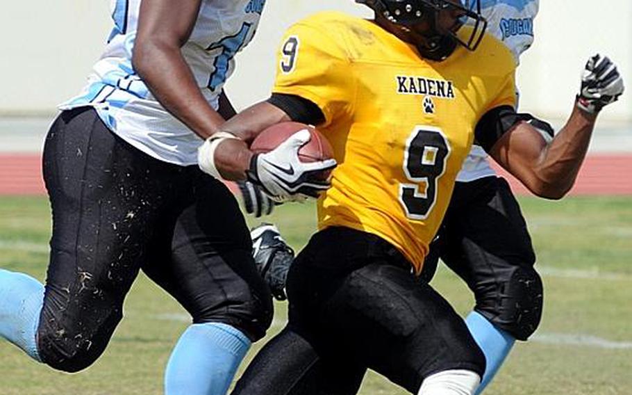 Kadena Panthers ball carrier Thomas McDonald eludes a pair of Osan American Cougars defenders during Saturday's interarea high school football game at Ryukyu Middle School, Kadena Air Base, Okinawa. The host Panthers routed the Cougars, 46-8.