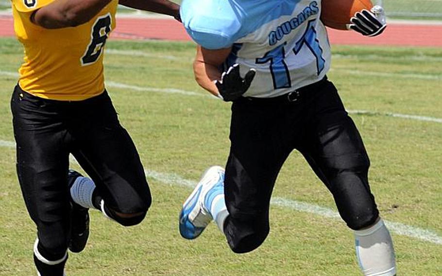 Osan American Cougars ball carrier Paul Snead gets chased by Kadena Panthers defender Tyrell Crutcher during Saturday's interarea high school football game at Ryukyu Middle School, Kadena Air Base, Okinawa. The host Panthers routed the Cougars, 46-8.